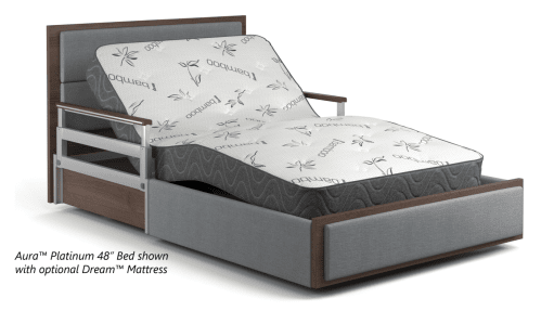 A bed with a wooden and metal frame featuring an adjustable base is shown with a mattress. The mattress has the word "Dream" written on it, and the bed is labeled as the "Aura™ Platinum 48” Bed," ideal for both home and hospital settings in any city across the USA.