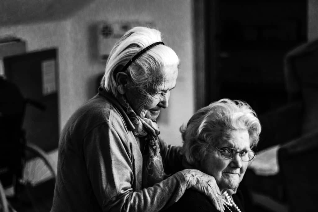 an old couple of people standing next to each other.