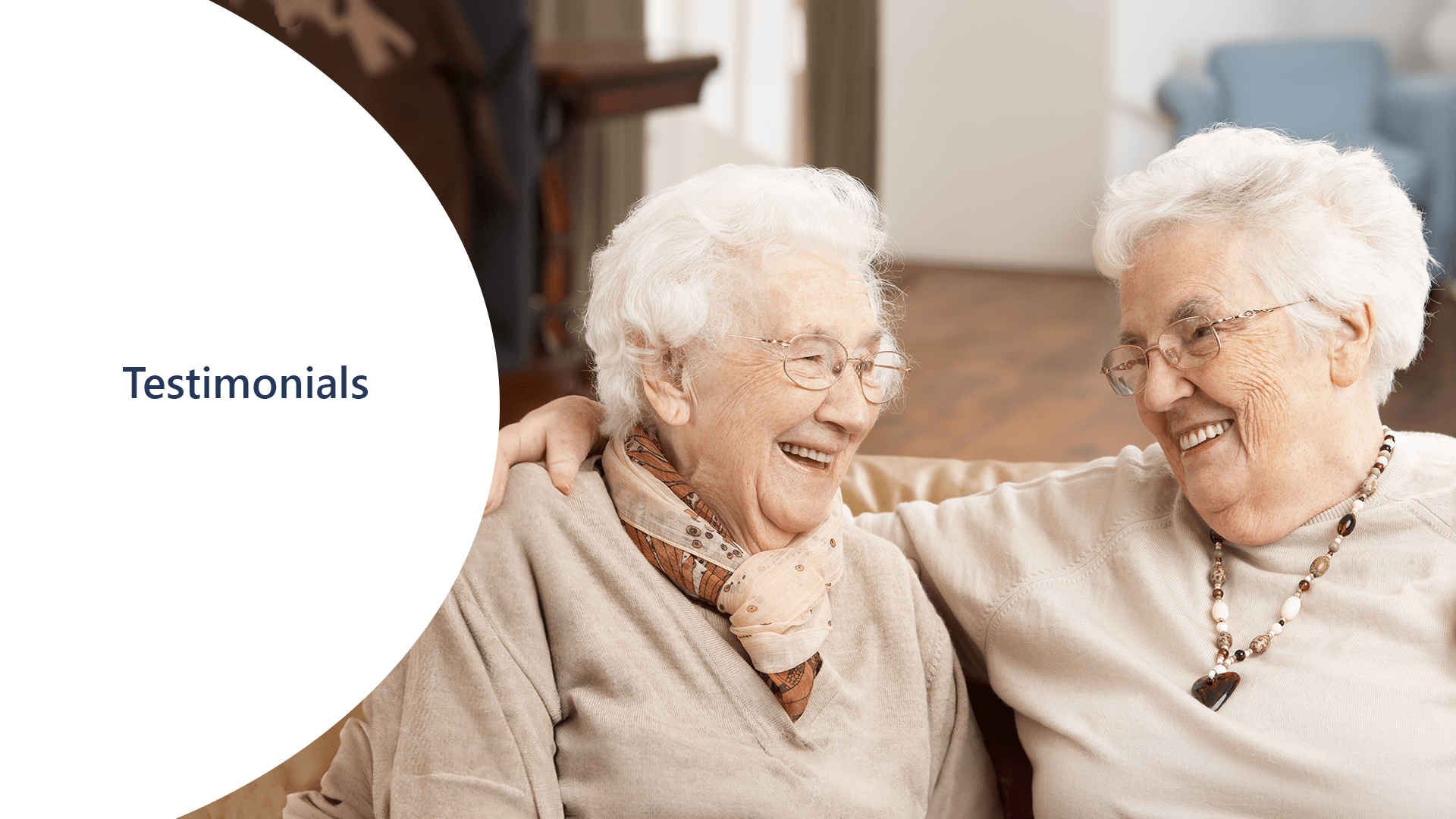 Two elderly women are smiling and sharing their testimonials.