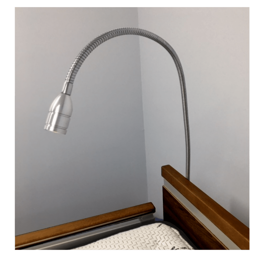 A flexible desk lamp, #15395, overhanging a wooden bedside table against a grey wall.