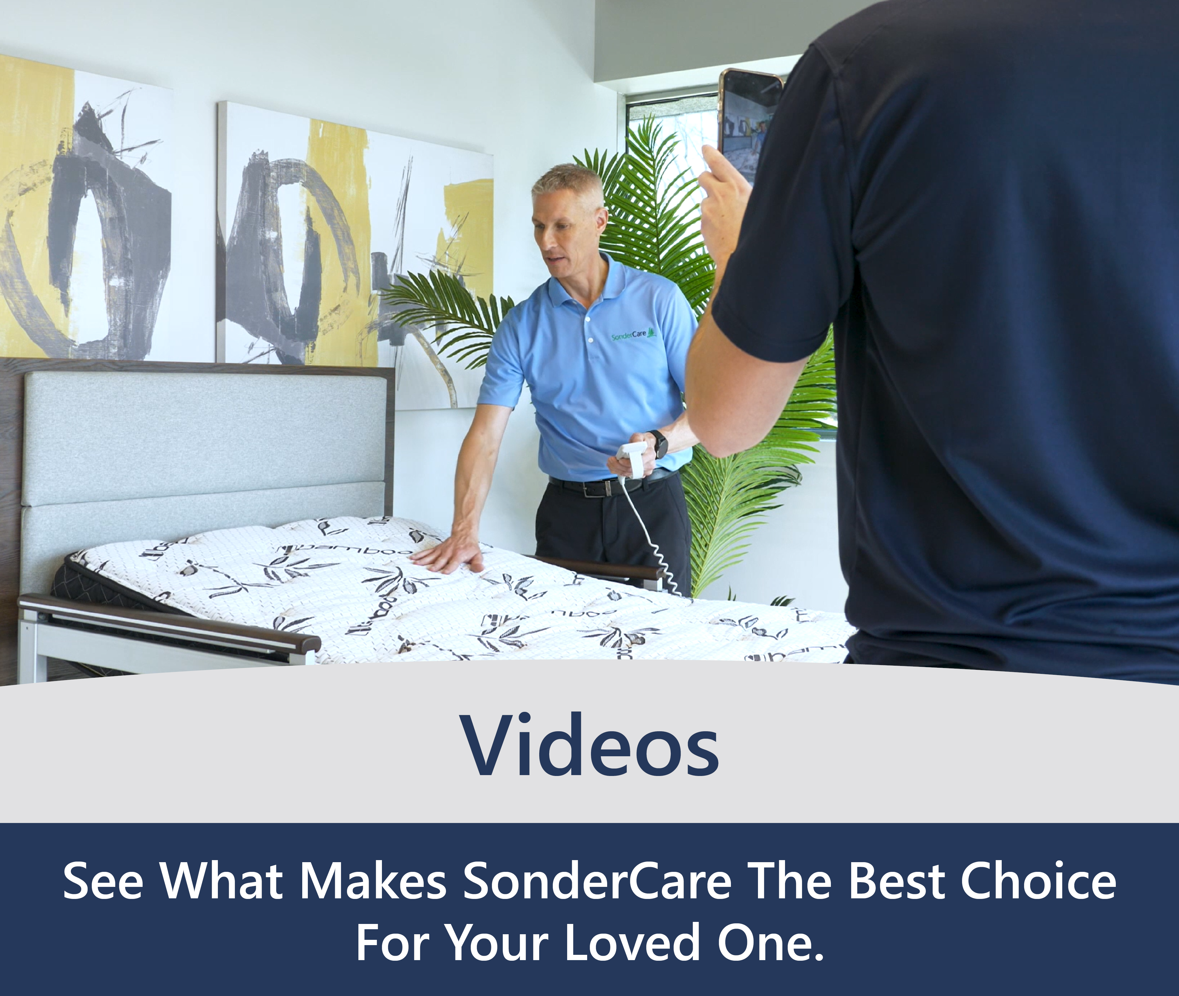 A man in a blue shirt demonstrates features of a bed, while another person films him. Banner text reads: "Videos – See What Makes SonderCare The Best Choice For Your Loved One.