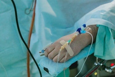 a person in a hospital bed with a cast on their arm.