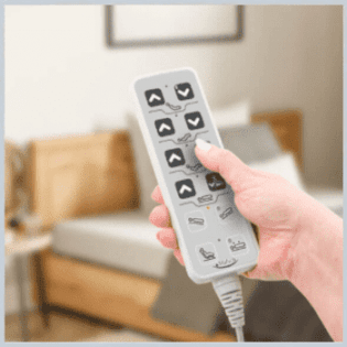 a person holding a remote control in their hand.