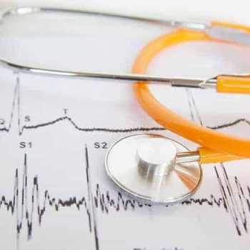 a stethoscope laying on top of a medical chart. a stethoscope laying on top of a medical chart.