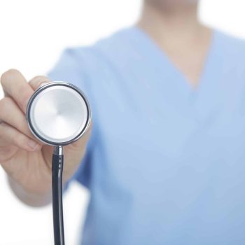 a person holding a stethoscope in their hand. a person holding a stethoscope in their hand.