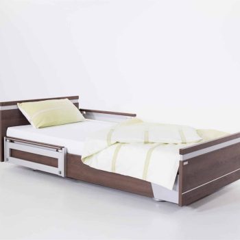 a bed with a wooden frame and white sheets. a bed with a wooden frame and white sheets.