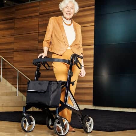 a woman standing next to a stair case.