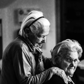 an old couple of people standing next to each other.