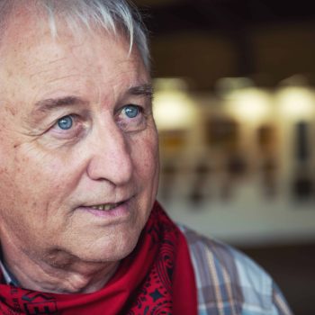 a close up of a person wearing a red scarf.