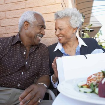 a man and a woman sitting next to each other at a table. a man and a woman sitting next to each other at a table.