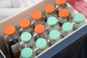 a box filled with lots of bottles of water.