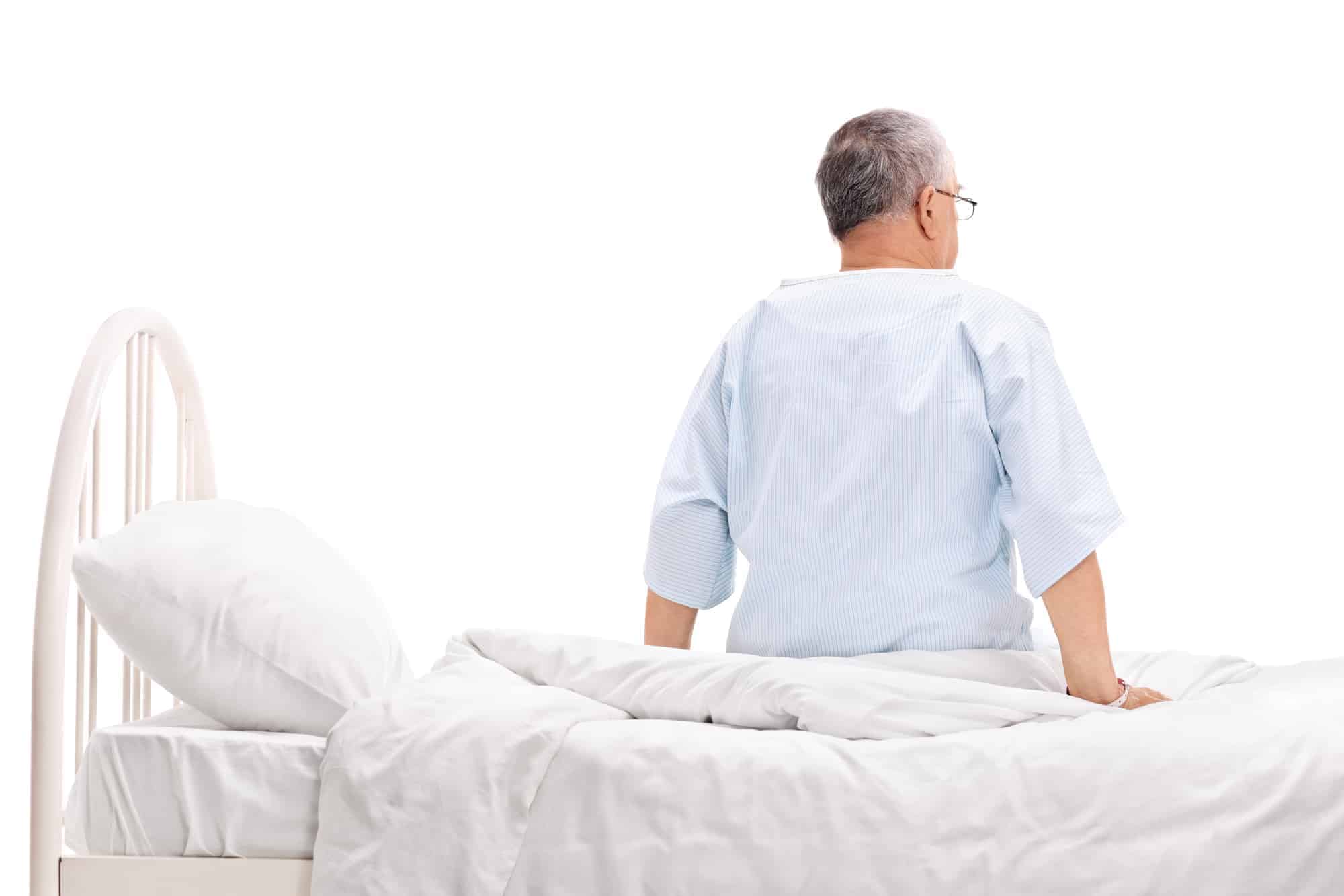 A man sitting on a wall with an electric adjustable bed.