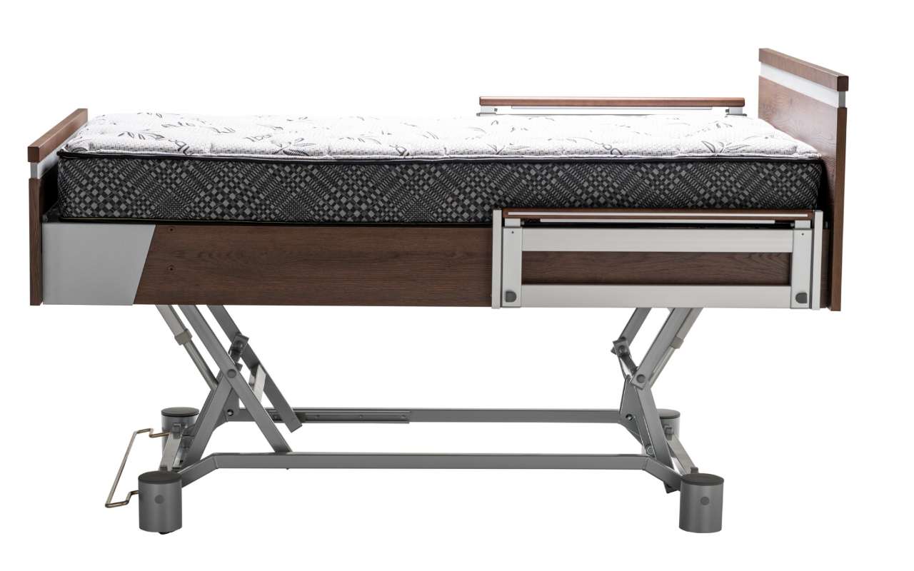 A hospital bed with a mattress, wooden panels at the head and foot, and adjustable metal frame with leg supports.