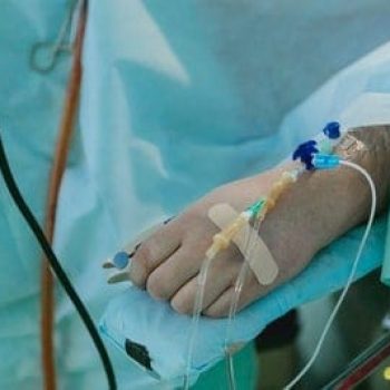 a person in a hospital bed with a cast on their arm.