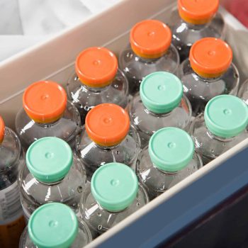 a box filled with lots of bottles of water.