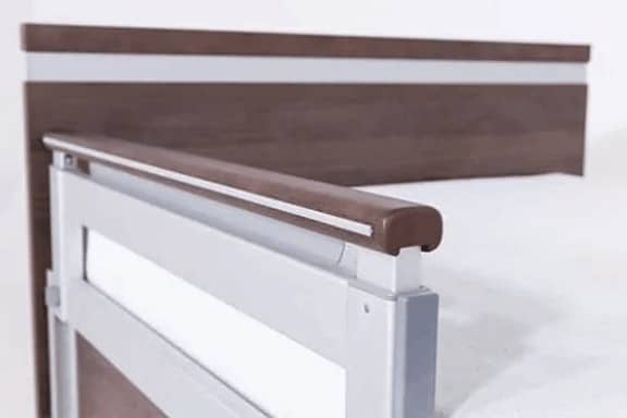 a close up of a bed with a wooden headboard.